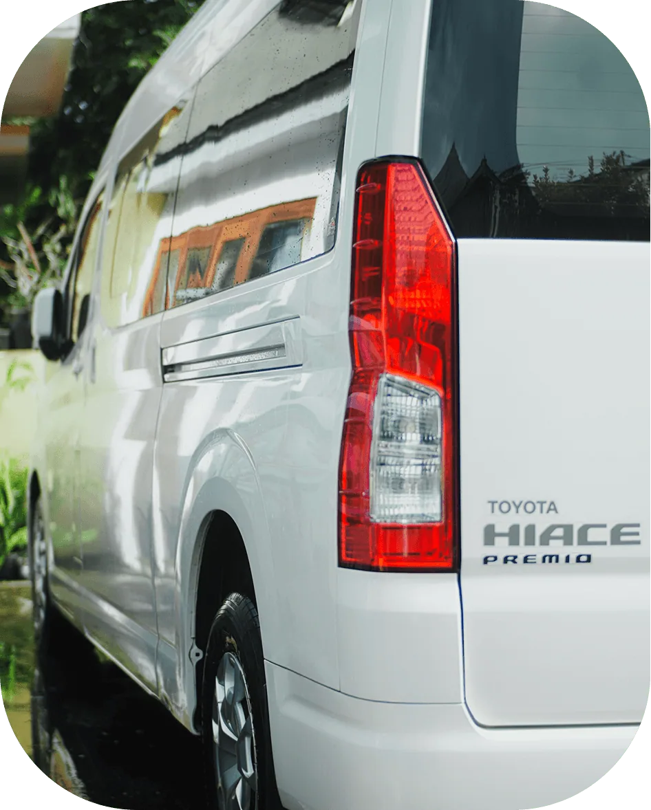 Rear view of a white Toyota Hiace Premio passenger van