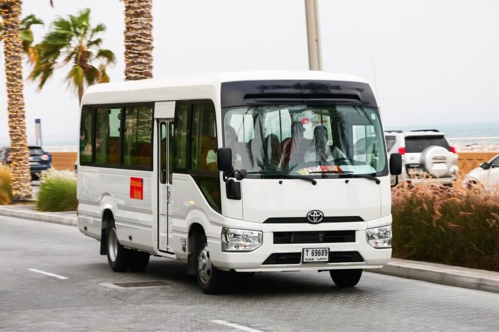 Toyota Coaster passenger bus used for professional transport services in Dubai by Alsinan Transport